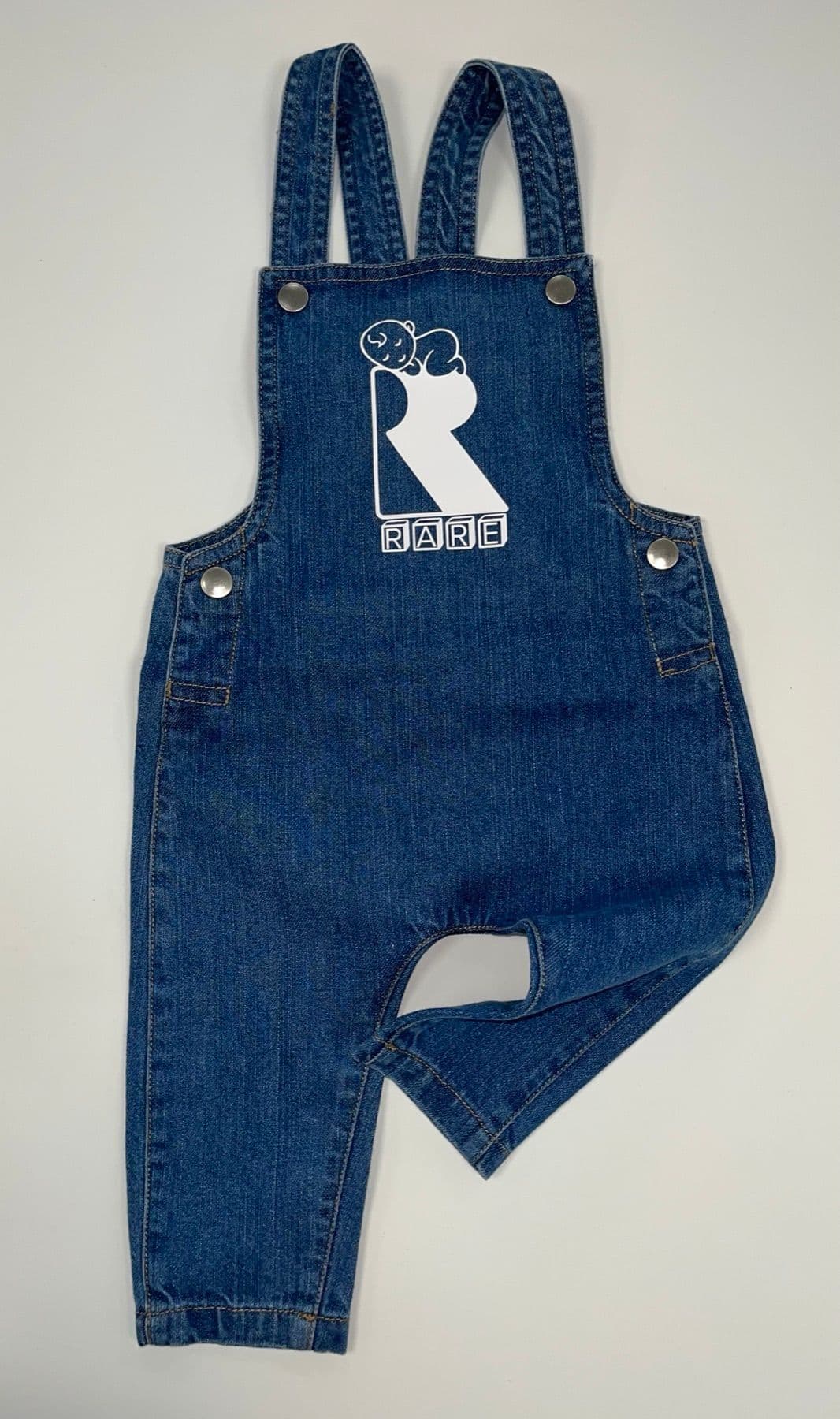 Denim baby dungarees with a printed logo