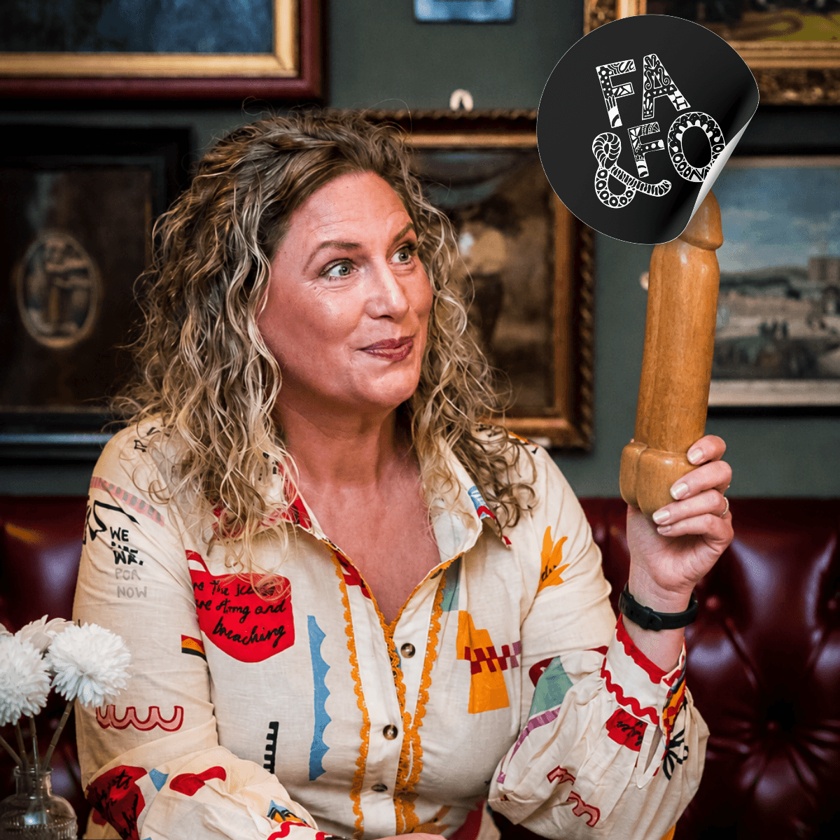 Tanya holds a wooden bottle opener shaped like a penis