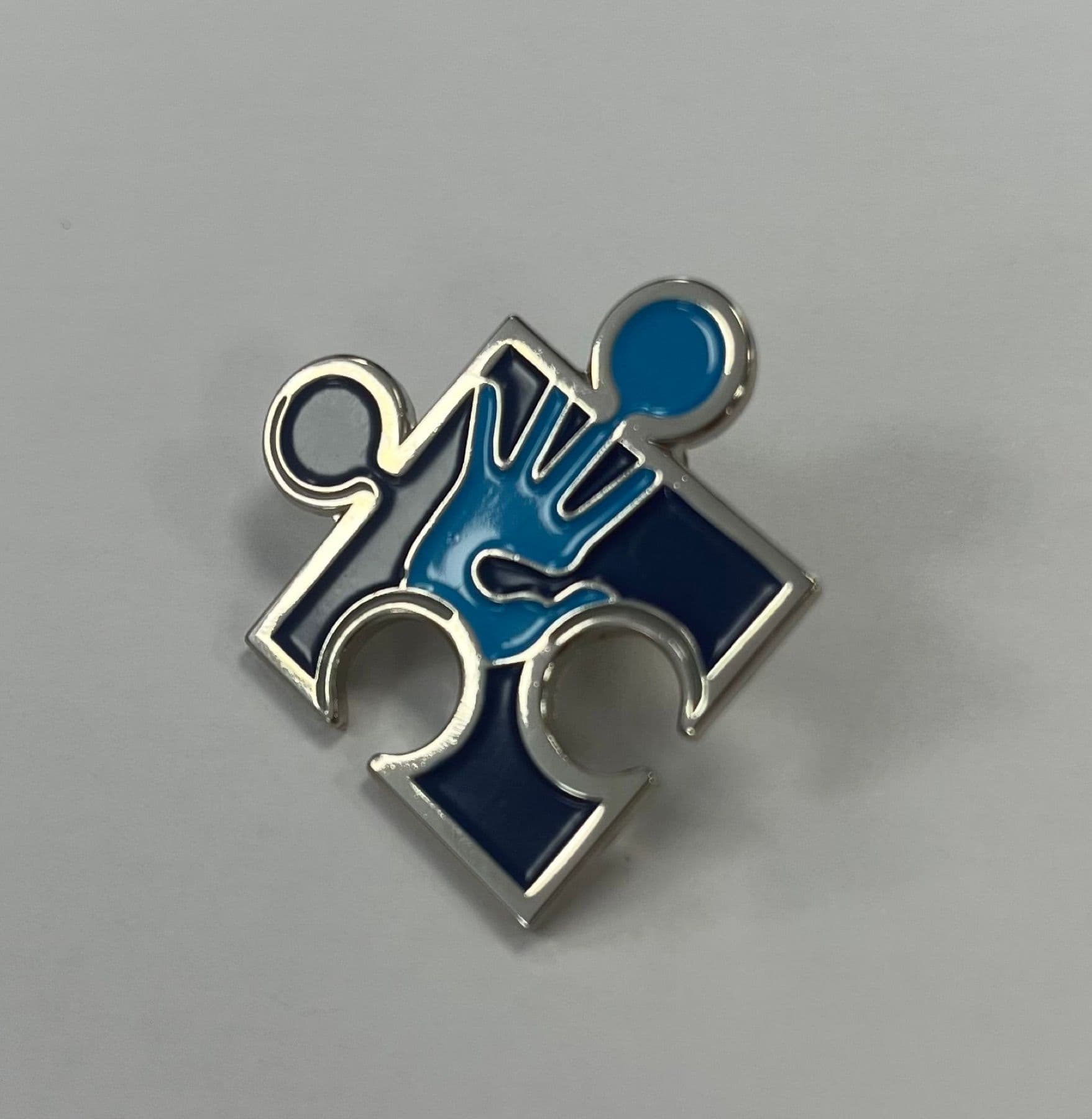 Enamel pin badge in a puzzle piece form