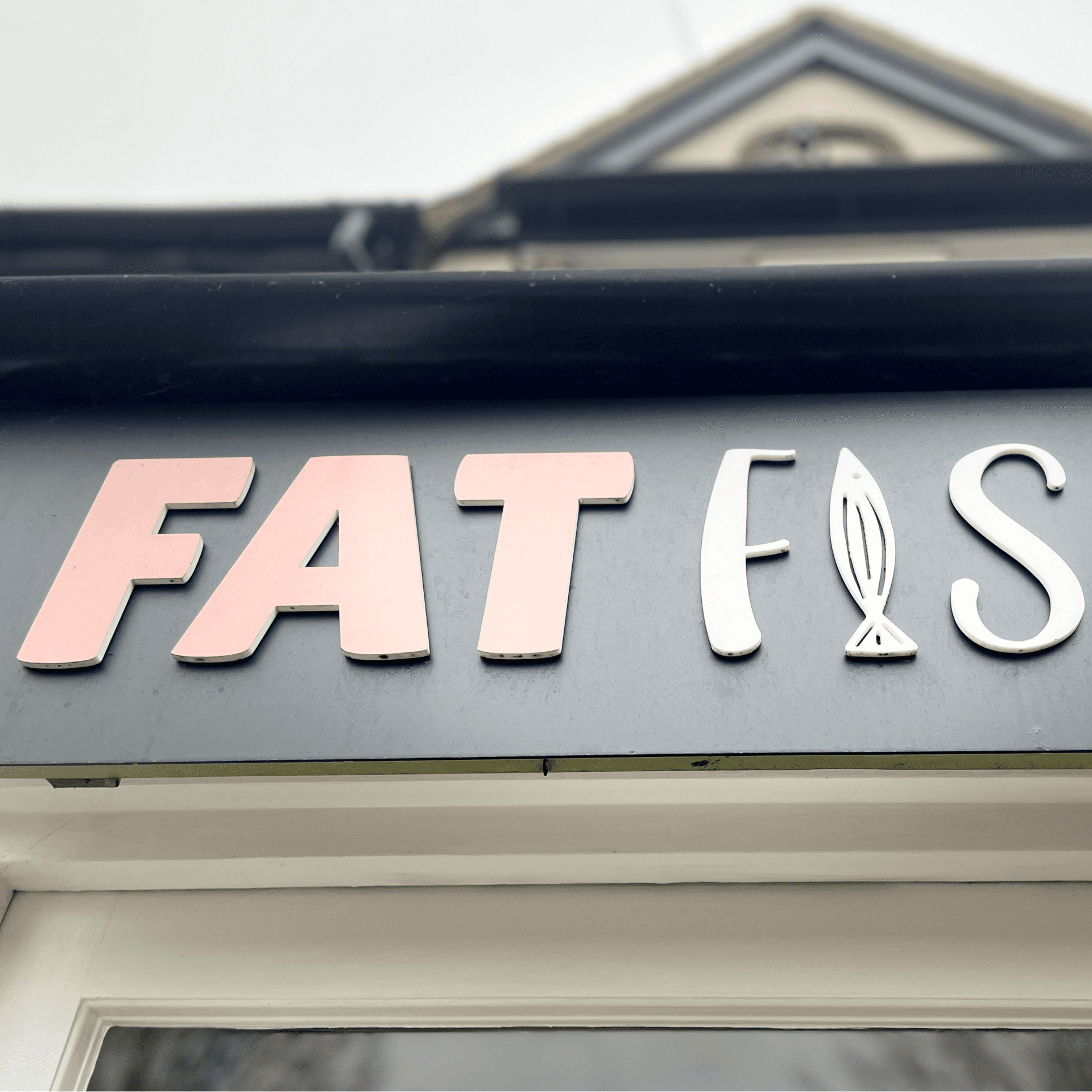 Fat Fish shopfront signage in pink and white lettering